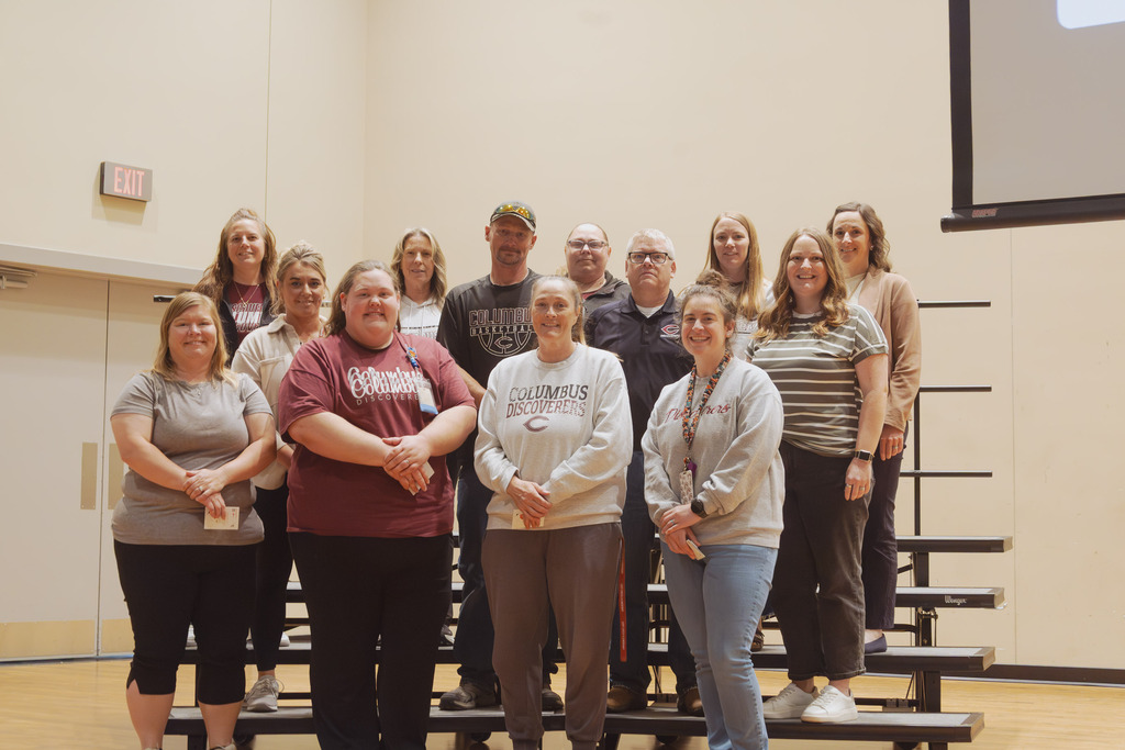 Photo of all 10 years of service employees standing on risers.