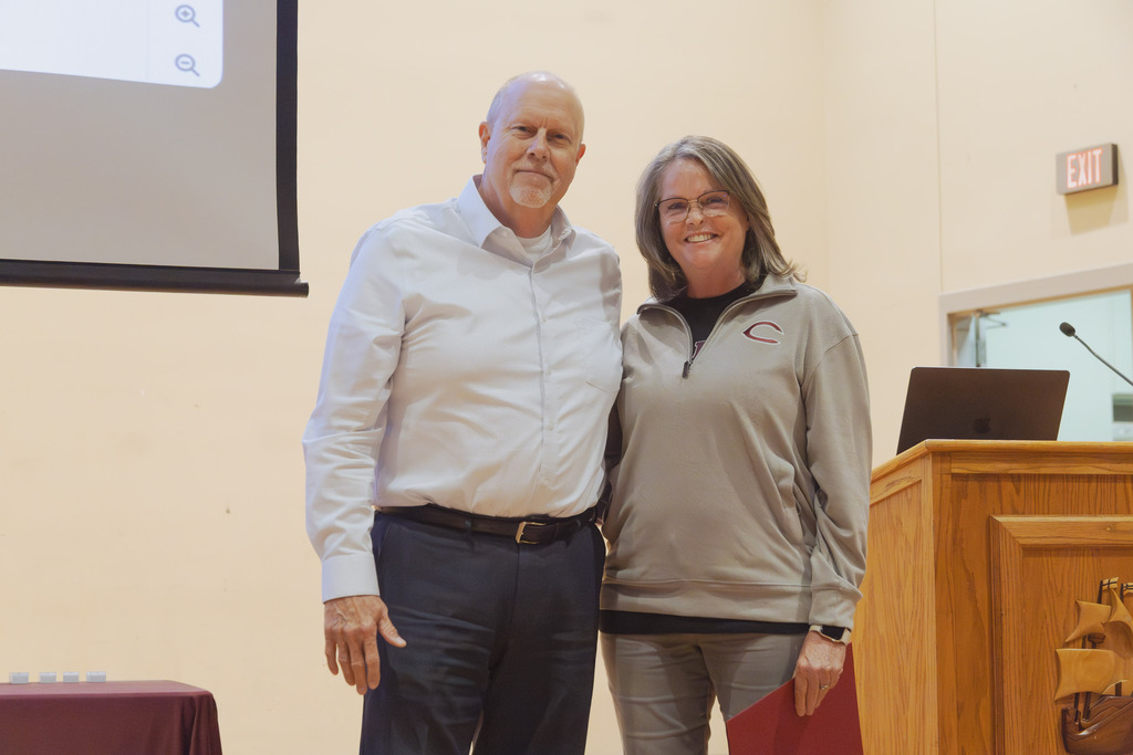 Brian Christensen and Anne Noviki are pictured standing on a stage