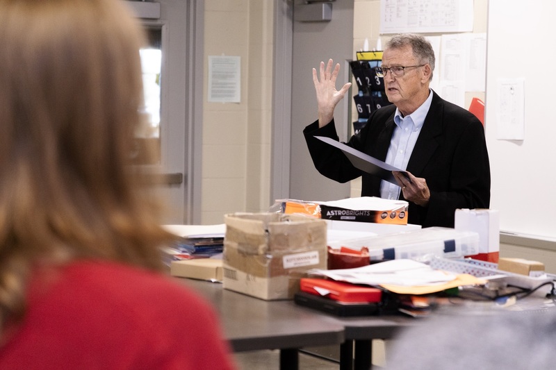 AFA Chapter 187 Secretary Marek Musick discusses the state level recognition Adam Whitmore was awarded. A CHS student is out of focus in the foreground.