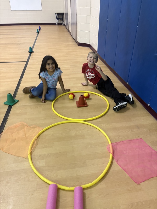 Students sitting by their turkey creation