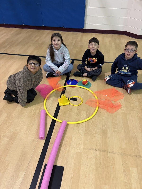 Students sitting by their turkey creation
