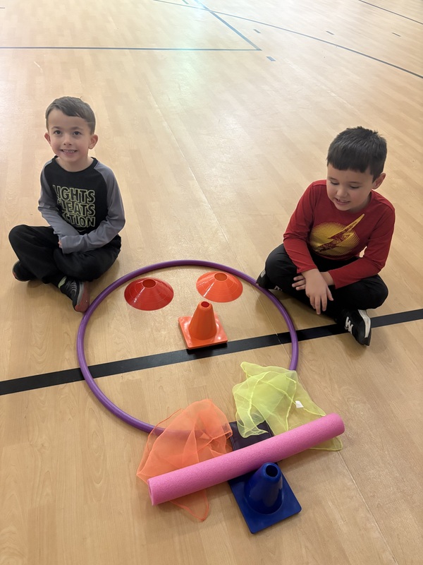 Students sitting by their turkey creation