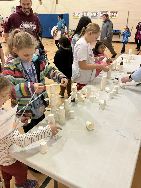 People at snowman stacking station