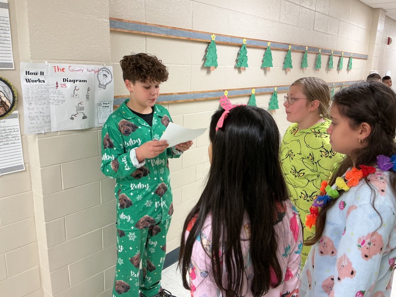 Student explaining their invention to peers.