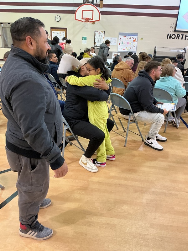 Parents hugging their children