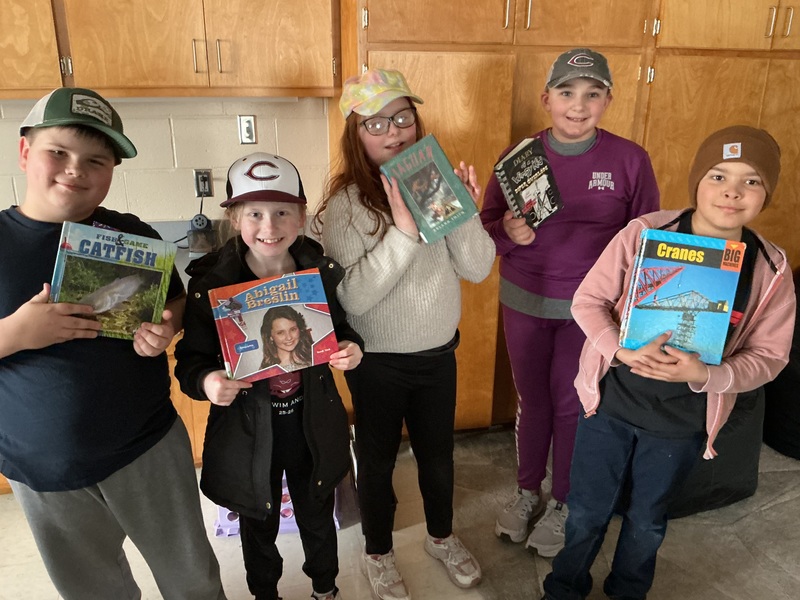 People in hats with books