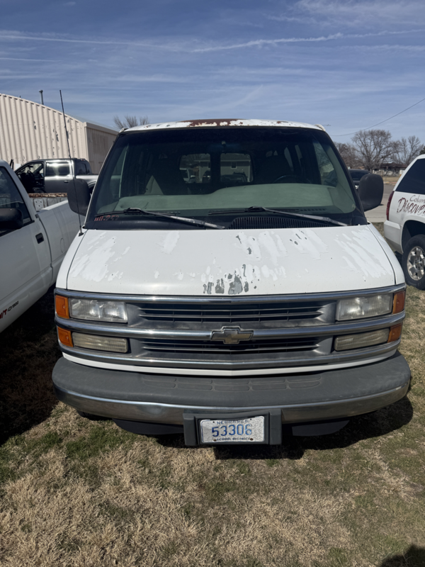 Front view of the white tech van displaying missing white paing
