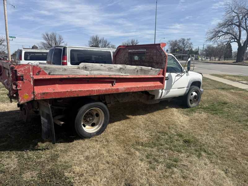 white dump truck with red bed