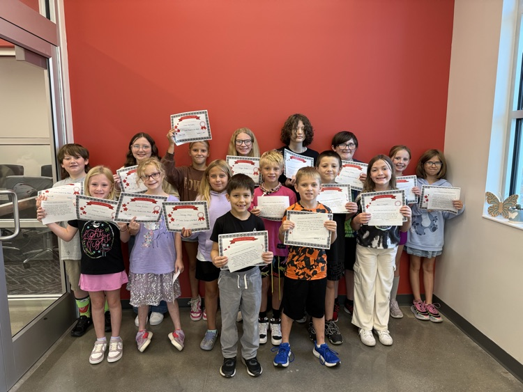 students stand holding their certificates