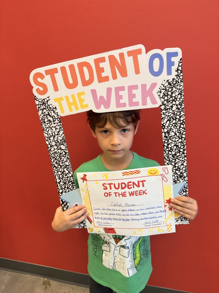 student of the week smiling and holding up certificate