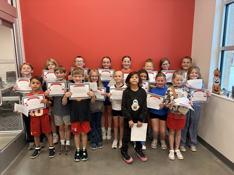 students hold their certificates up smiling