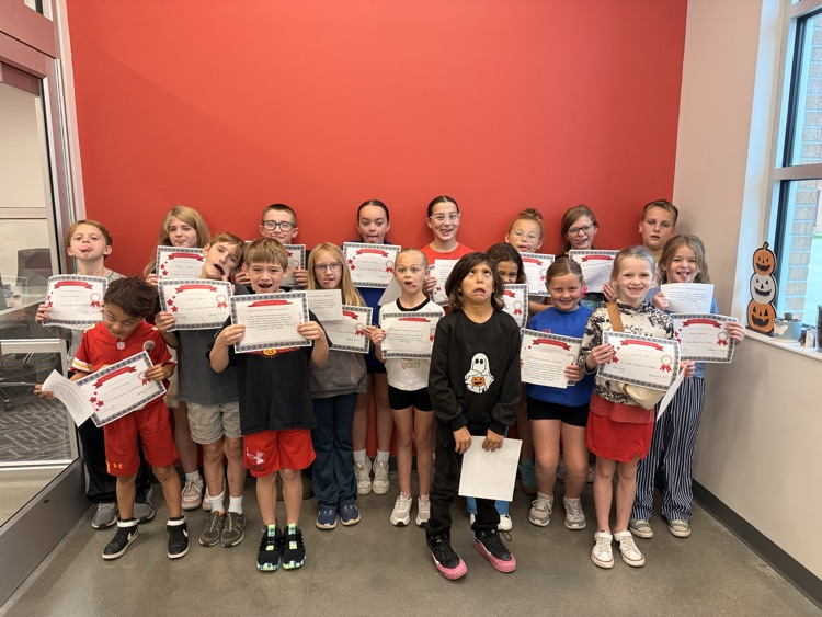 students hold their certificates up making silly faces