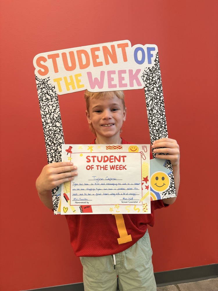 Tyson holding student of the week sign