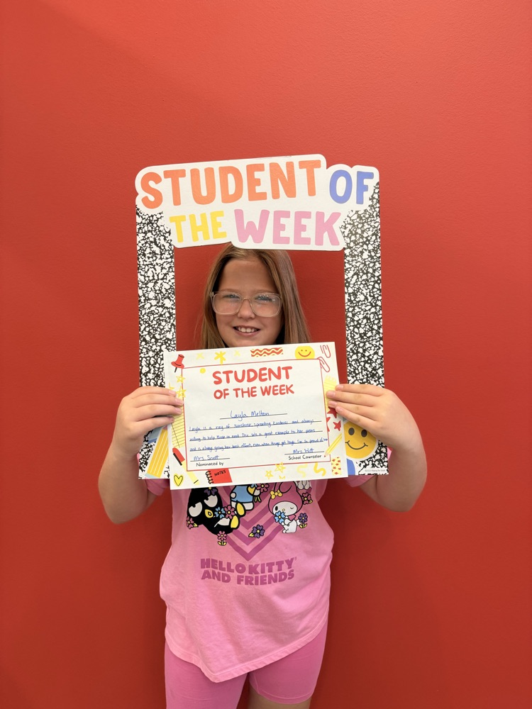 Layla holding student of the week sign