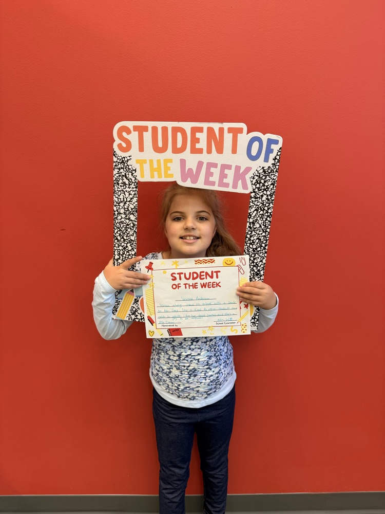 Verona holds up student of the week sign 