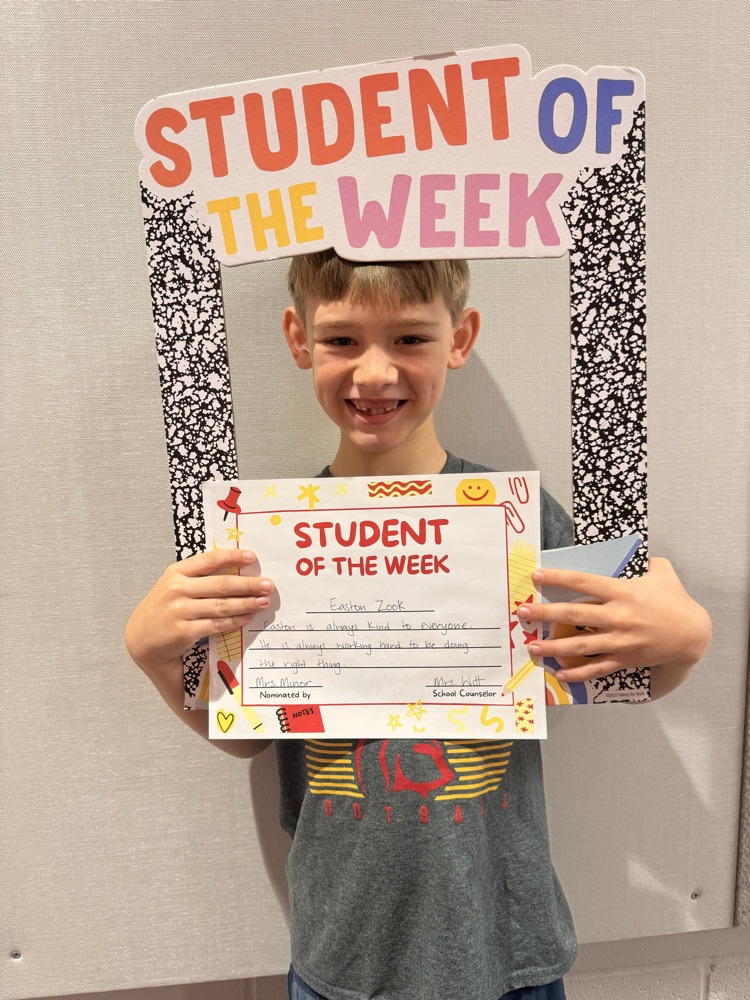 student holds up student of the week certificate 