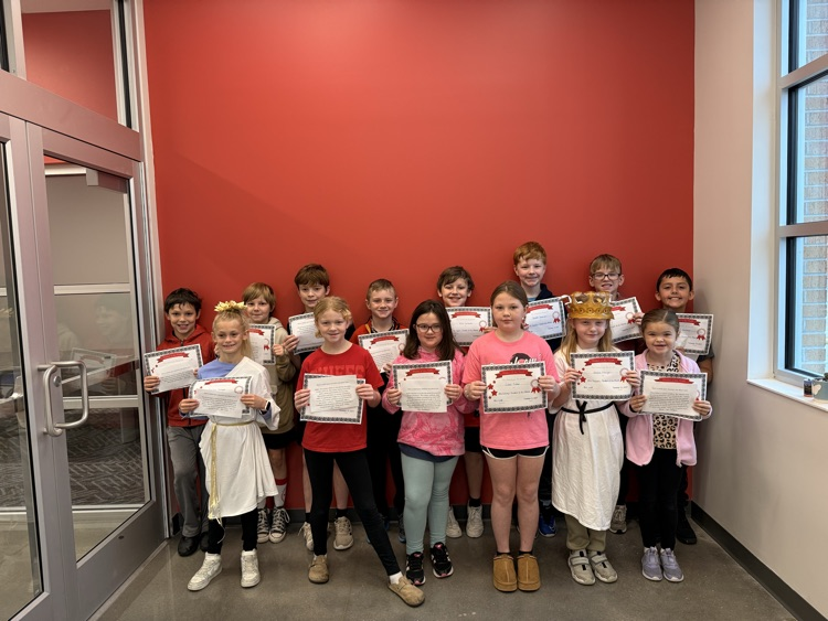 students stand smiling holding certificates