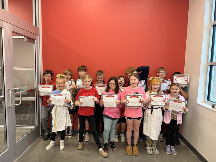 students make silly faces holding their certificates 