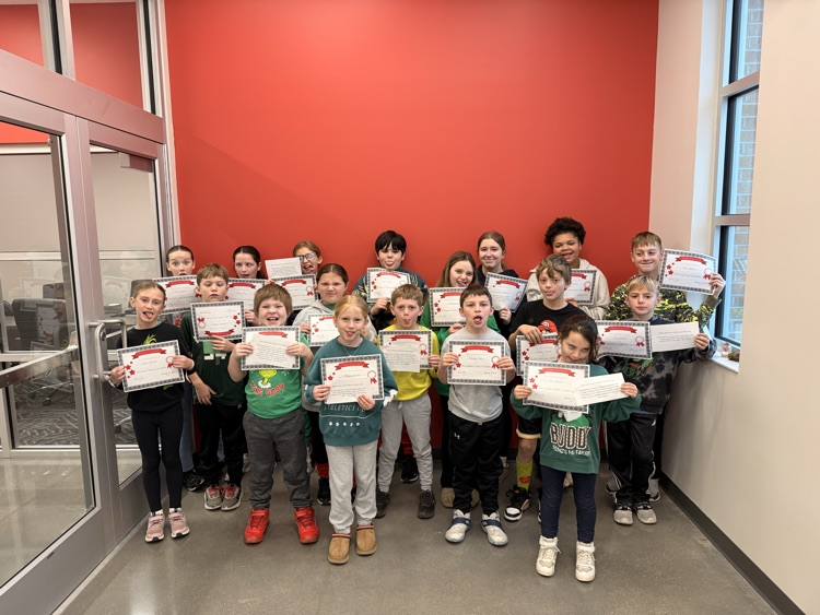 students make silly faces holding their certificates 