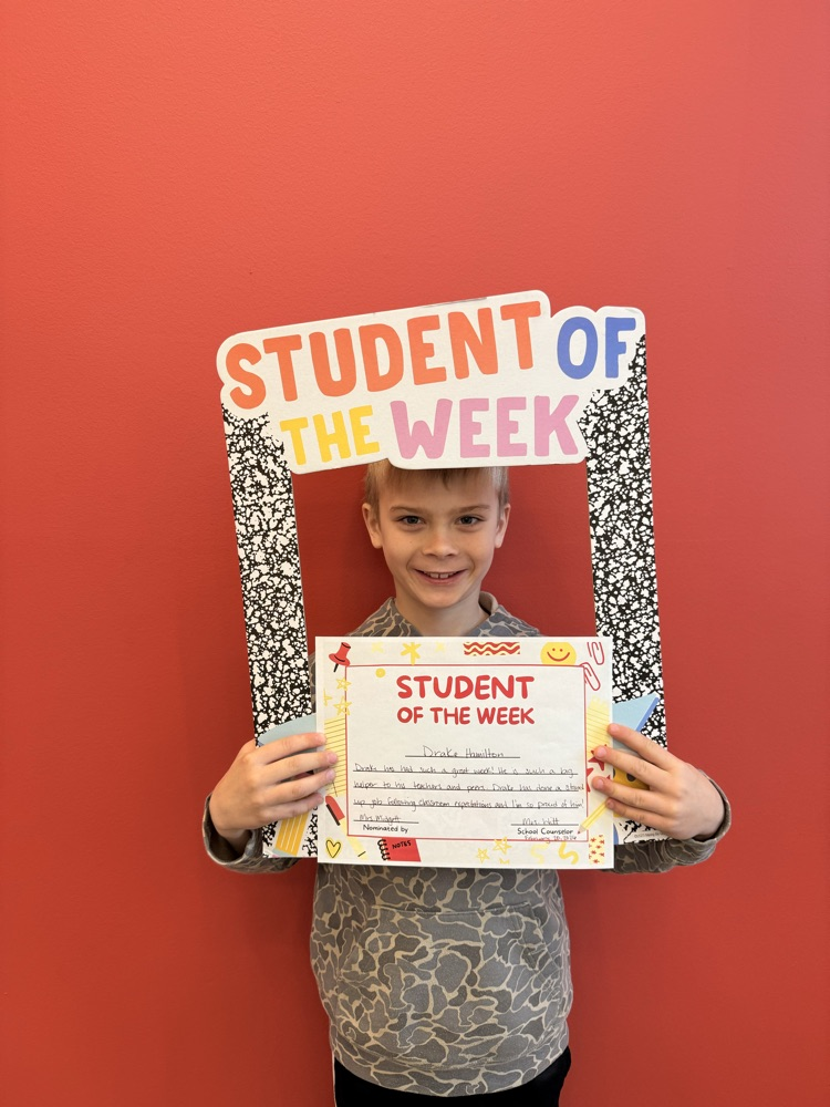 student of the week holding sign and certificate 