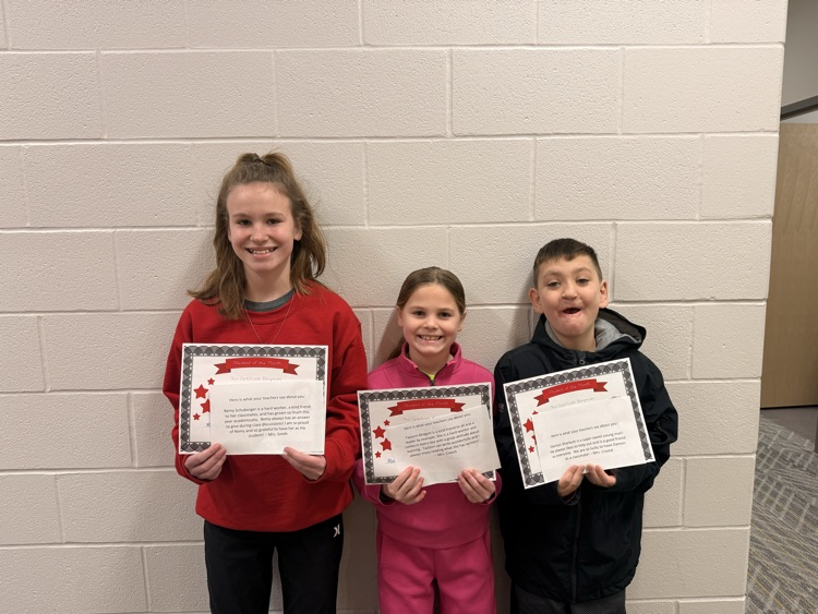 students hold up certificates 