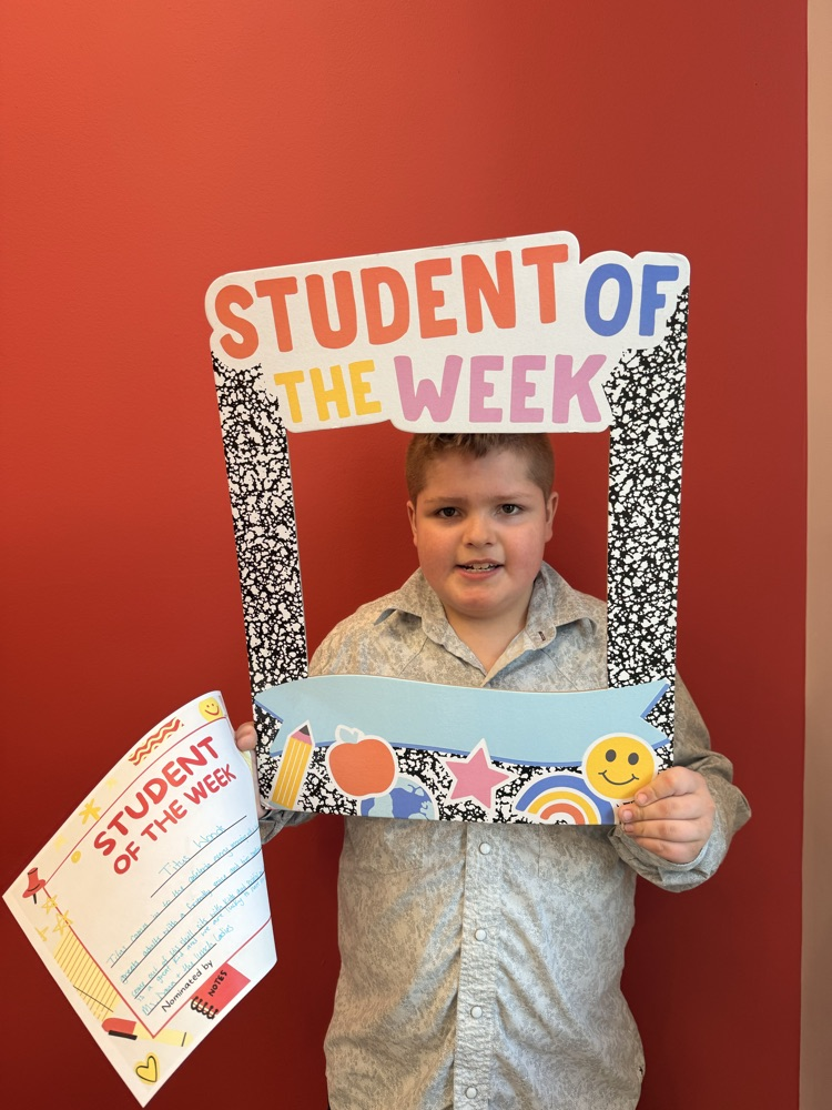 student holds up sign and certificate 