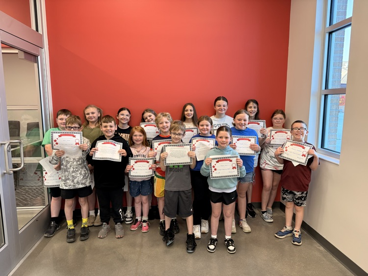 students smile holding signs