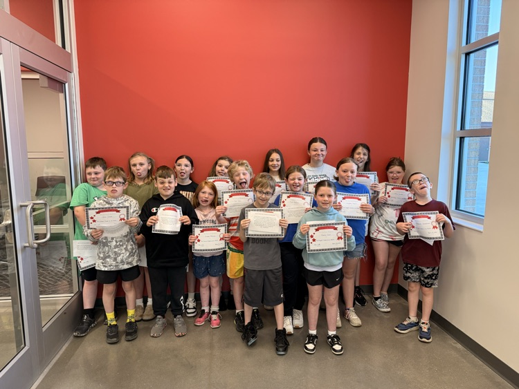 students make silly faces holding signs 