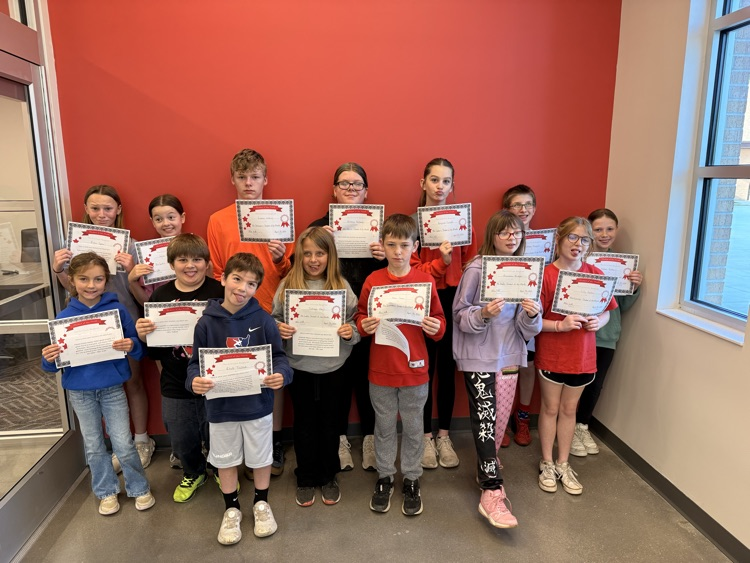 students make silly faces while holding certificates 