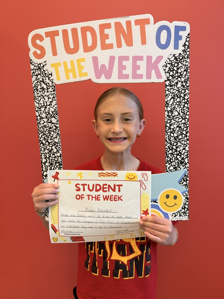 student smiles holding certificate