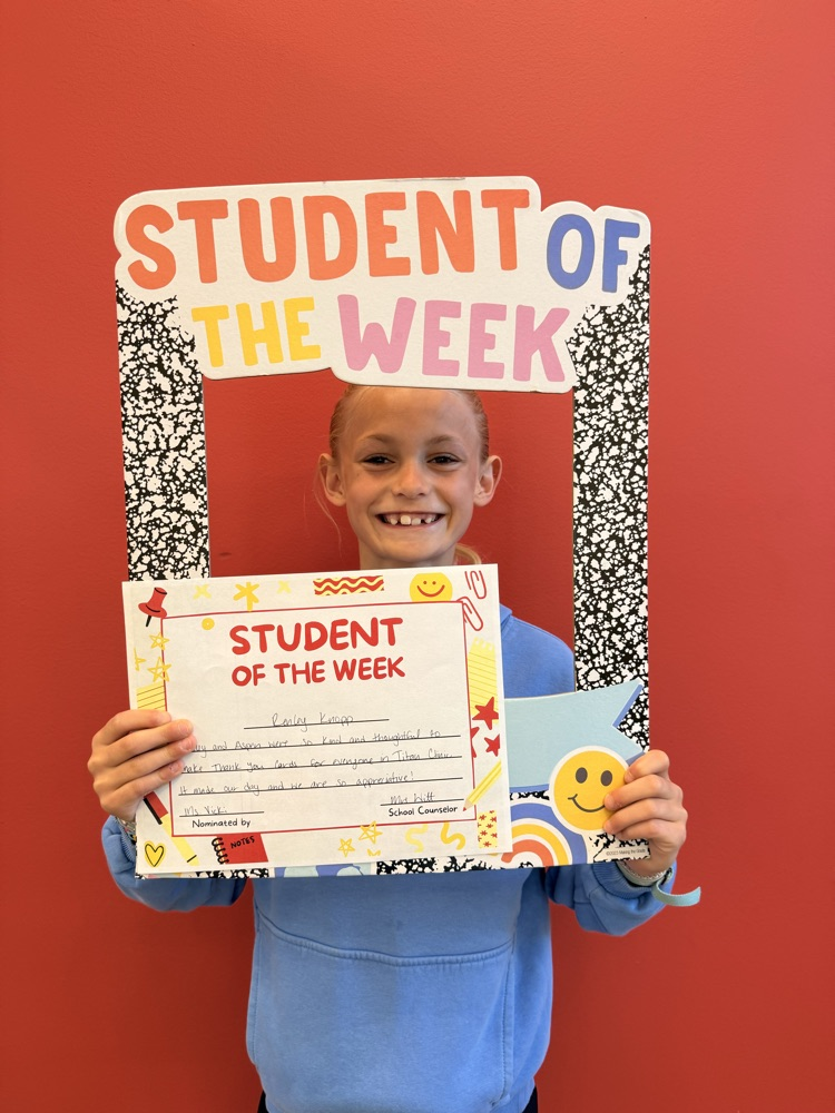 student smiles holding certificate 
