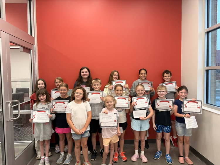 students smiling holding up certificates