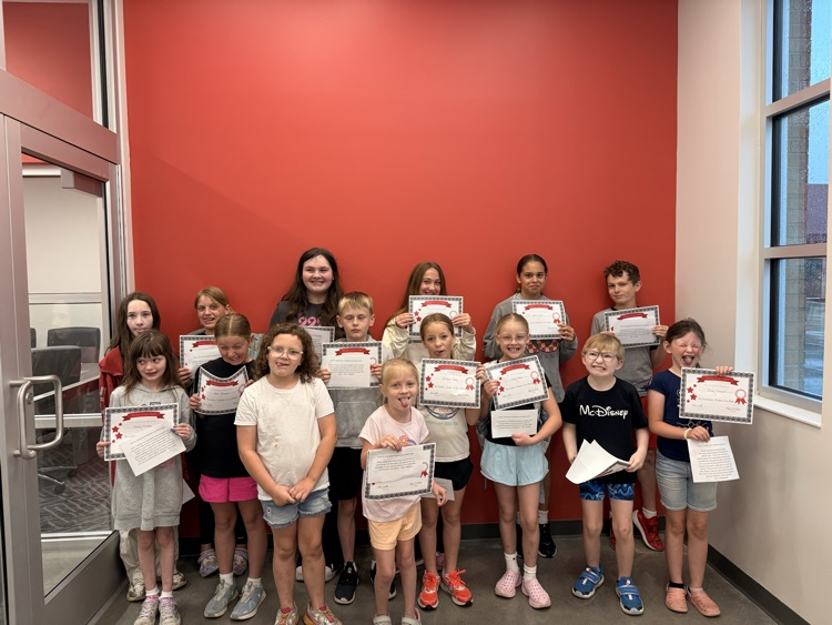 students making silly faces holding up certificates