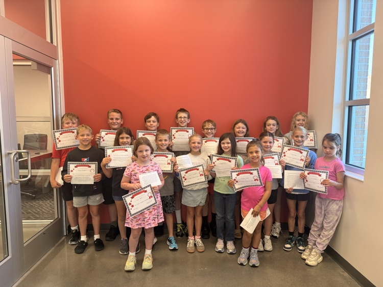 students smile holding their certificates 