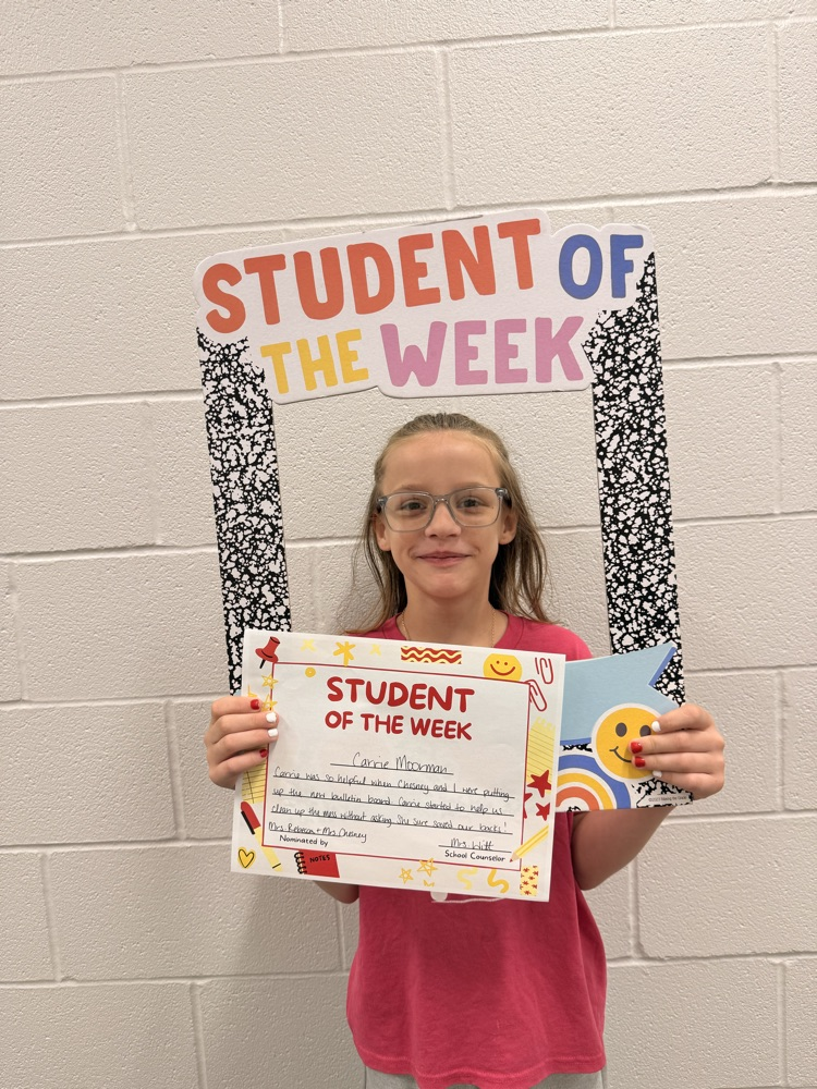 student smiles holding certificate