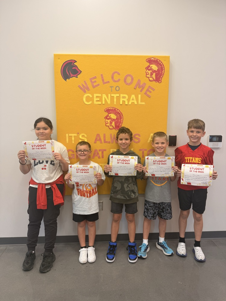 students smile holding certificates