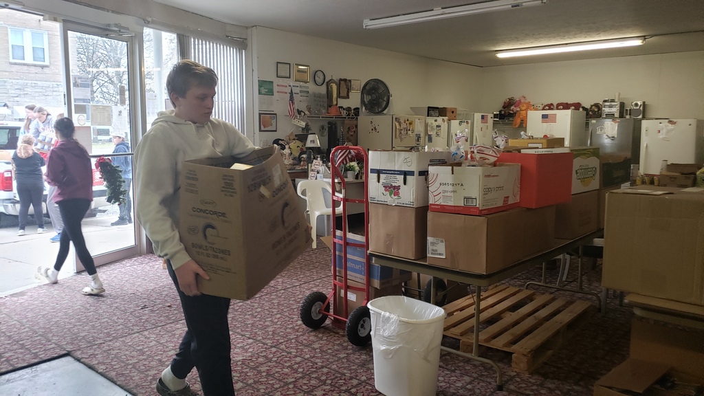 student carrying box inside