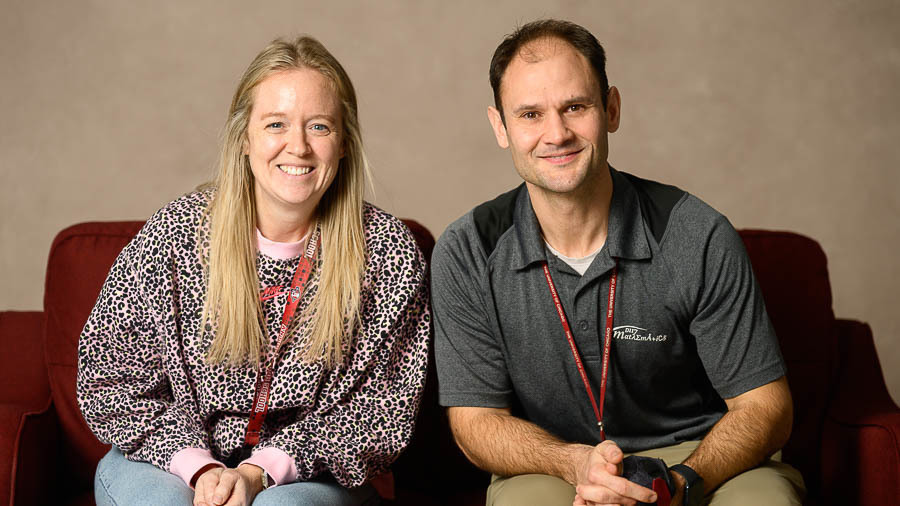 Sarah Weir and Ryan Hlinak pose on a couch for staff of the month pic.