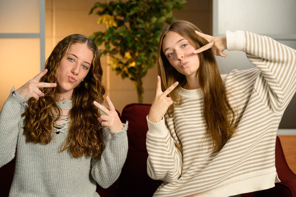 Two girls pose on morning show set.