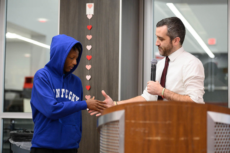 teacher and student shake hands