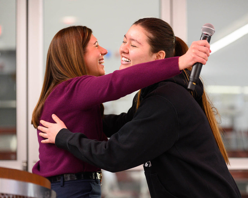 student and teacher hug