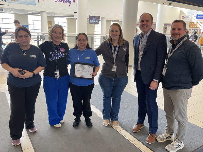 Group of 6 people awarding a certificate