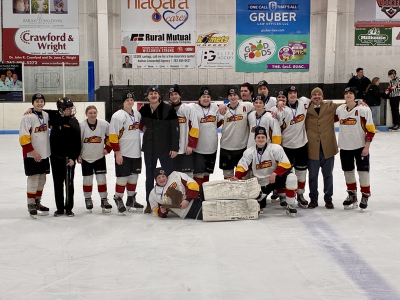 Teenage Hockey Team on ice with trophy