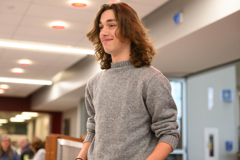 boy leaves podium with award