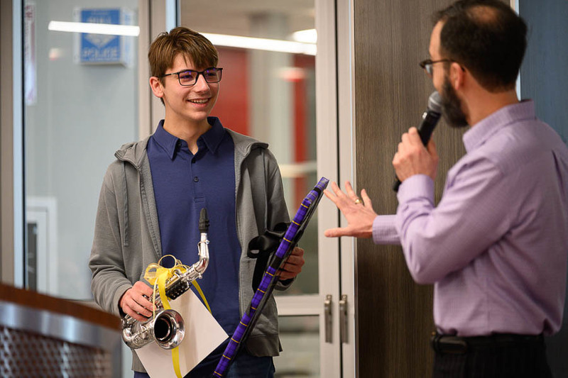 teacher presents award to student