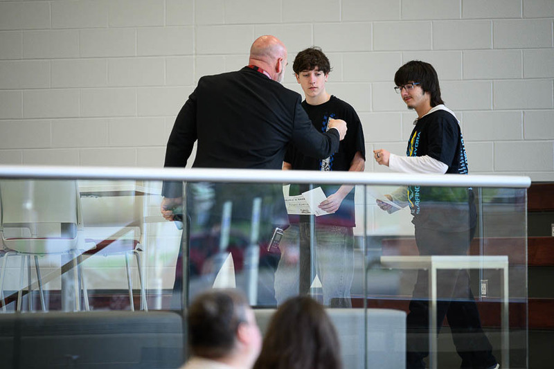 Student fist bumps principal