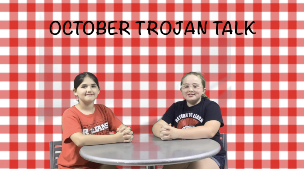 Students sitting at a table hosting the Elementary Trojan Talk