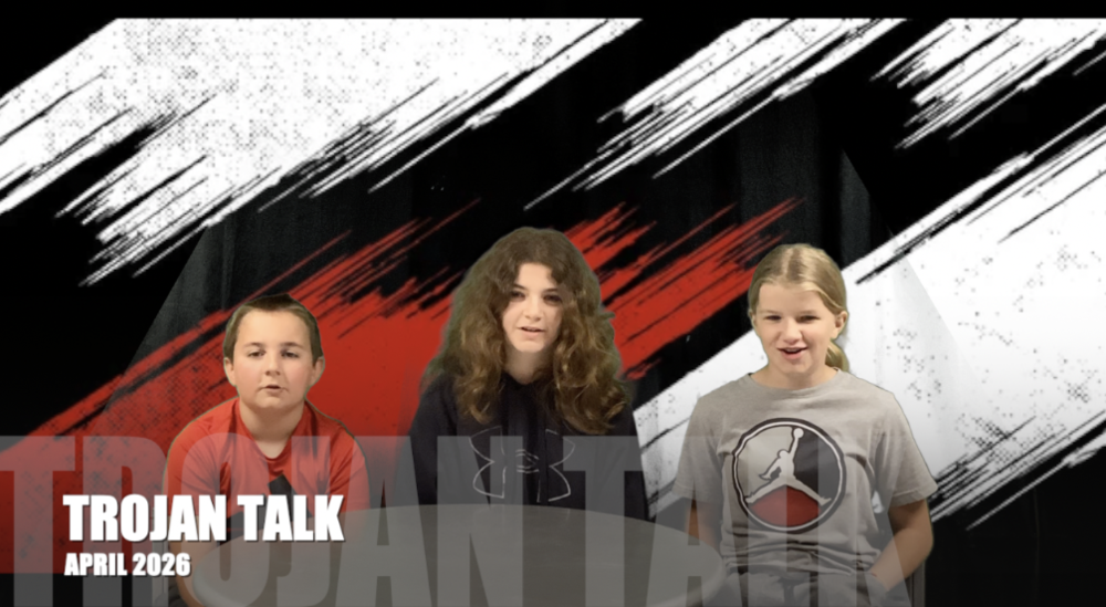 3 fifth graders sit in front of a red black and white background