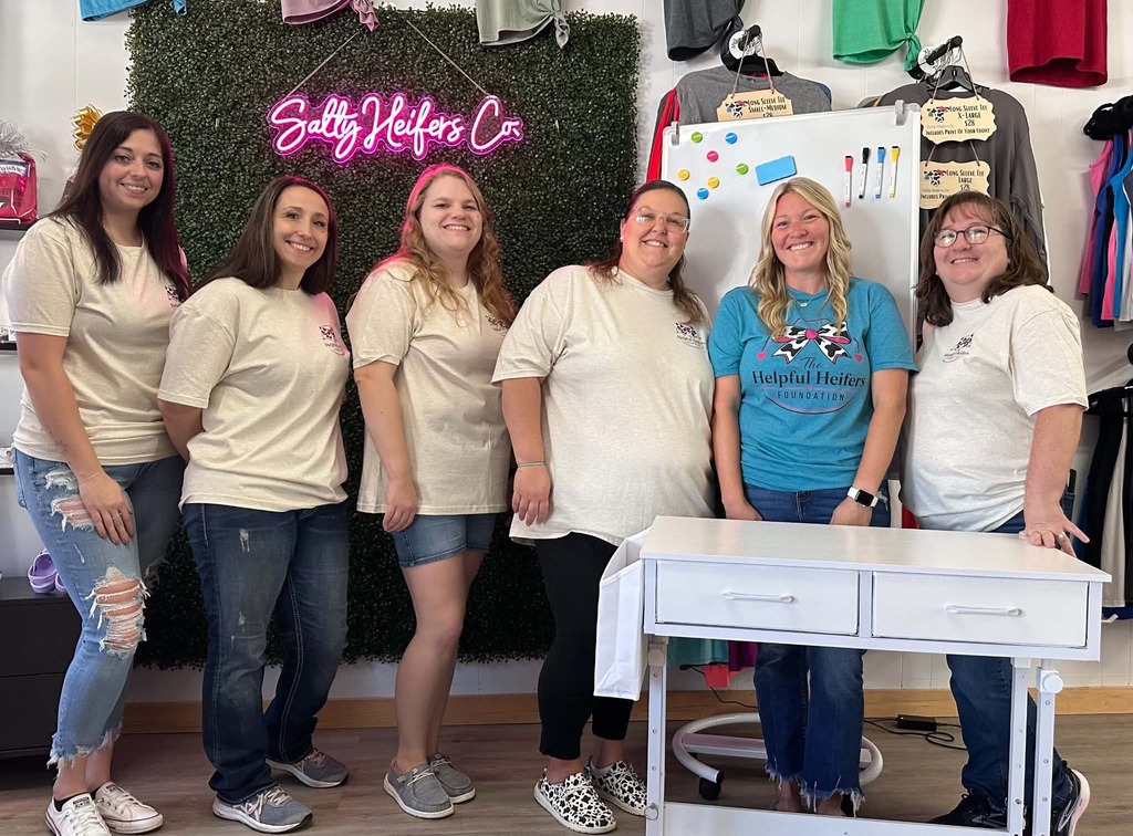 Congratulations to Miranda Fennewald, who received a grant from The Helpful Heifers Foundation on August 21, 2026. She applied for a rolling adjustable standing desk and a magnetic mobile whiteboard for her classroom. Teachers are encouraged to apply at TheHelpfulHeifers.Com   Pictured L to R, The Helpful Heifers Foundation Board  Kaitlyn Clithero, Nikki Taylor, Jacie Jones, Lindsy Swaim, Miranda Fennewald, and Barb Jones.  