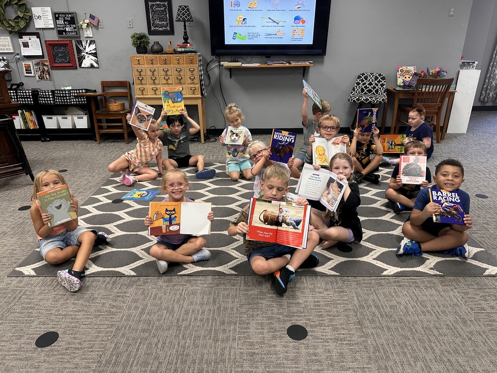 Students holding library books. Last week our kindergarteners experienced the joy of checking out their very first library books!